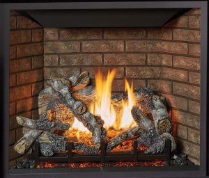 This is an image of a traditional ProBuilder 42 CF gas fireplace by Fireplace X featuring birch oak log set and common brick interior