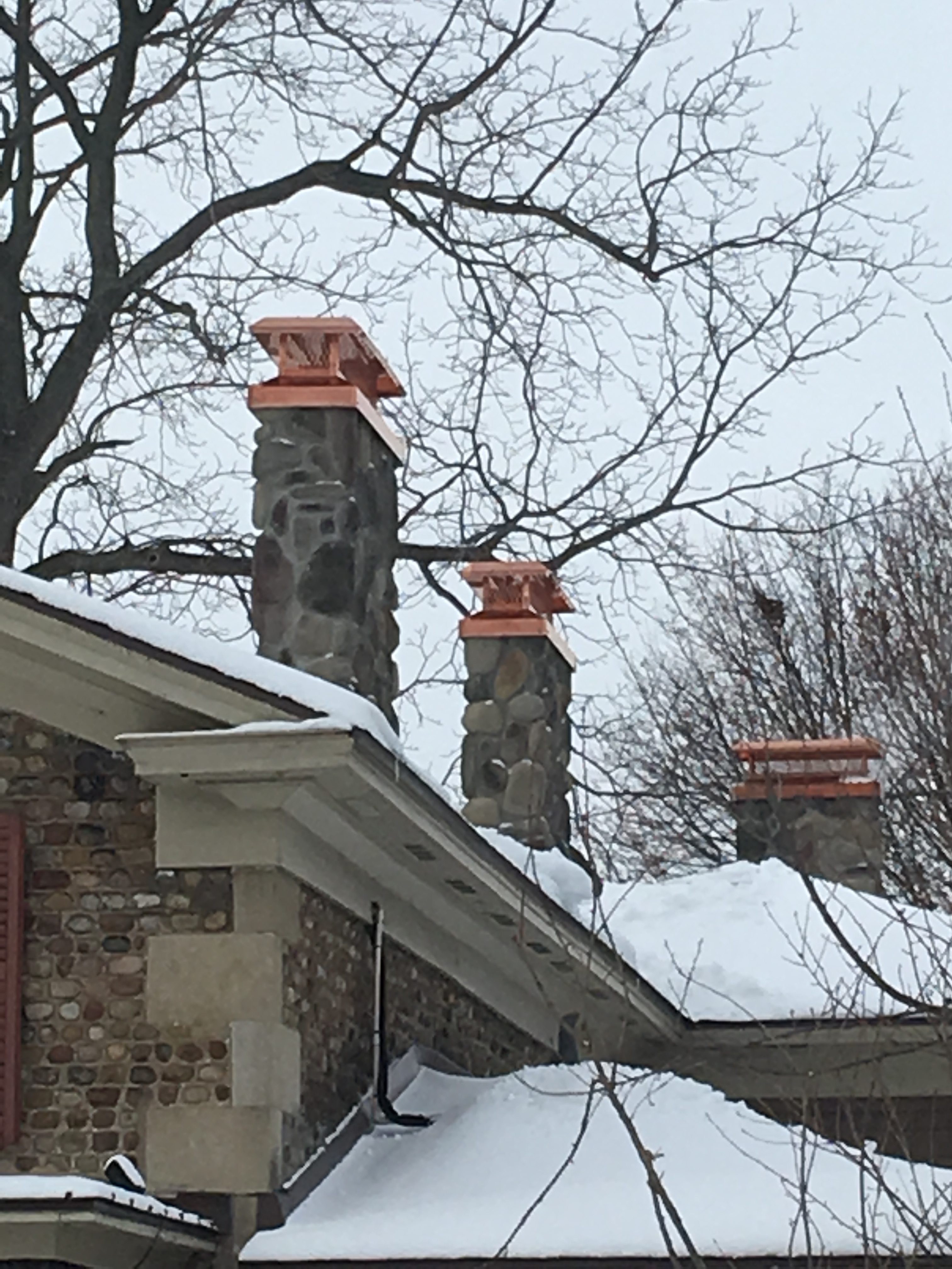 Image of sleep Copper Chimney Caps by Hy-C featuring rustic stone chimneys.