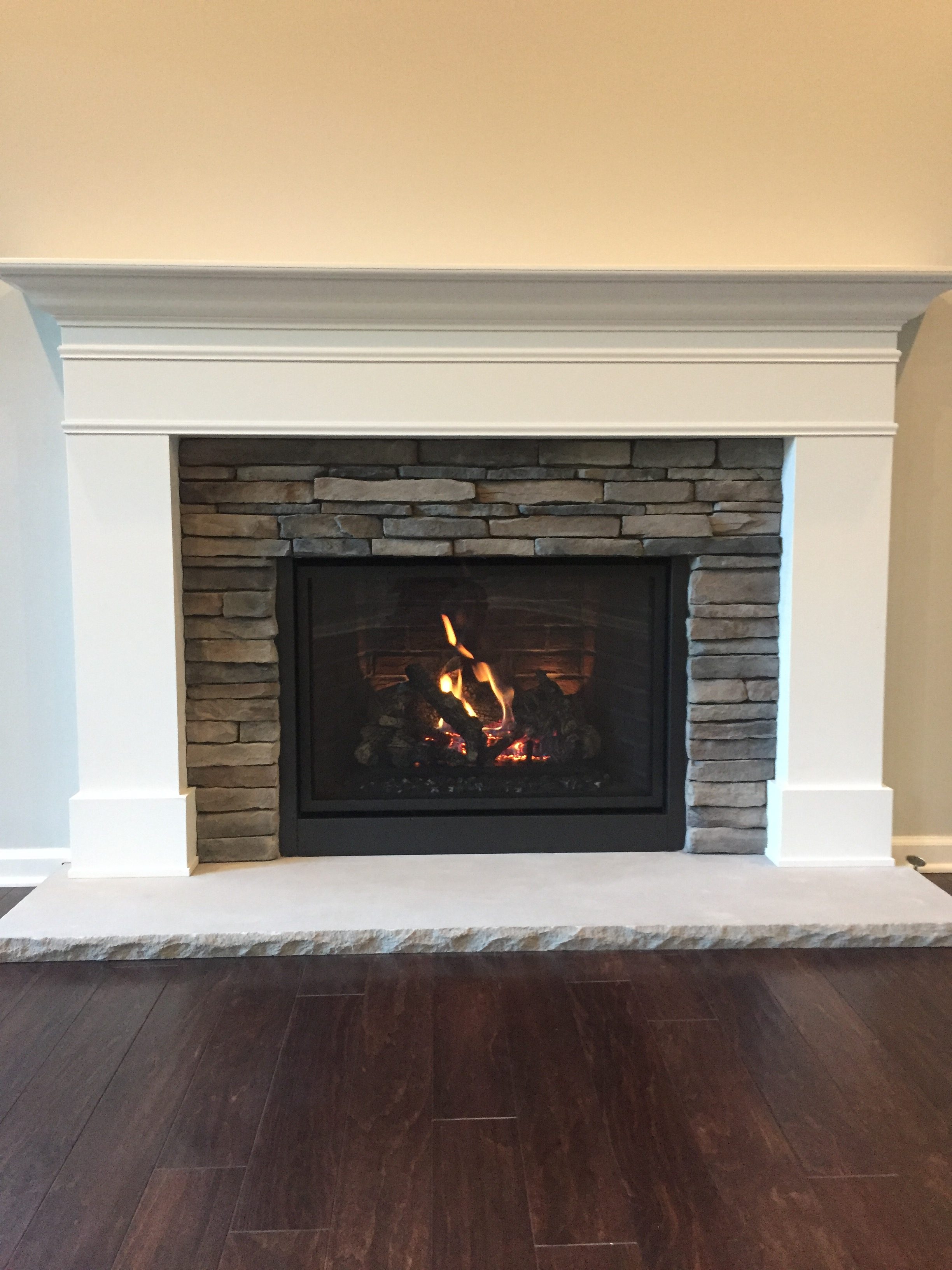 Image of a traditional 864TRV CleanFace gas fireplace by Travis Industries featuring stone facing and mantle.