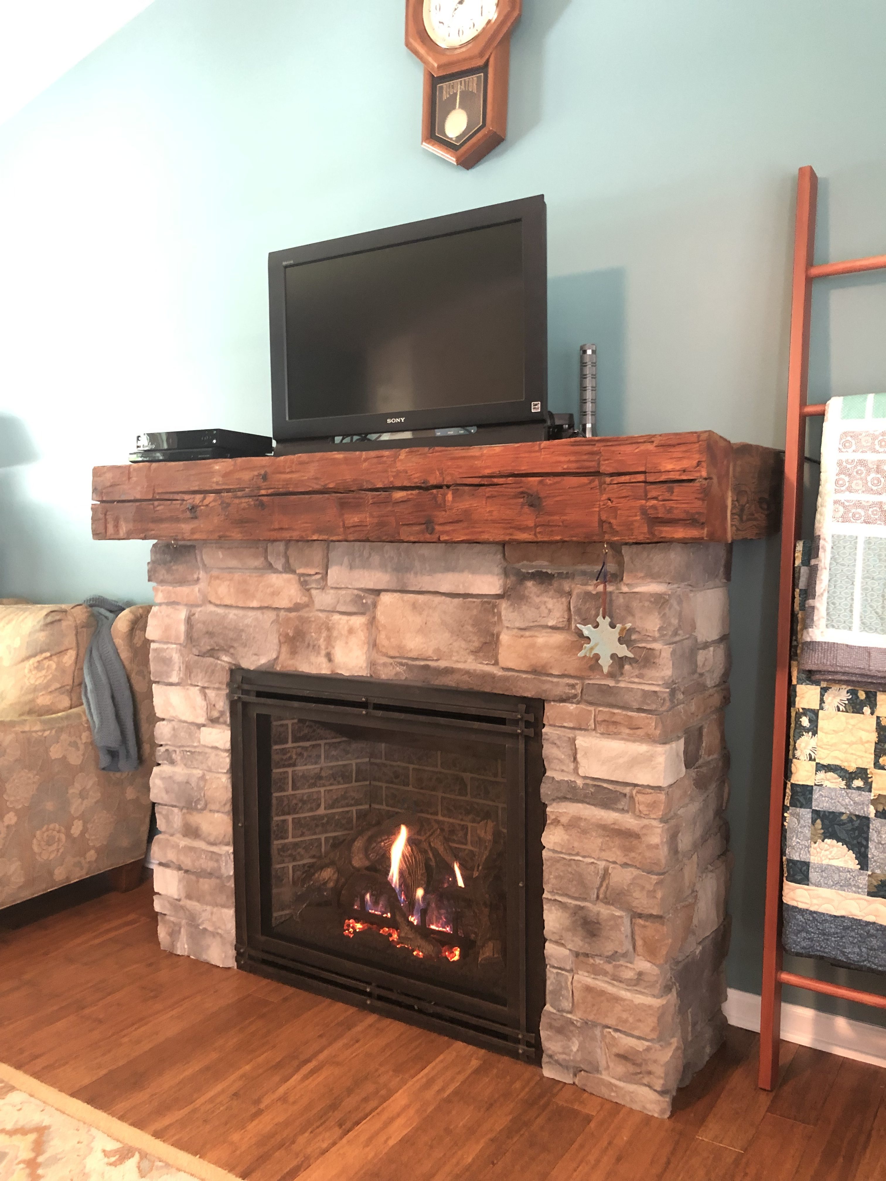 Image of a traditional Bayport 36-L gas fireplace by Kozy Heat featuring stone facing and mantle.