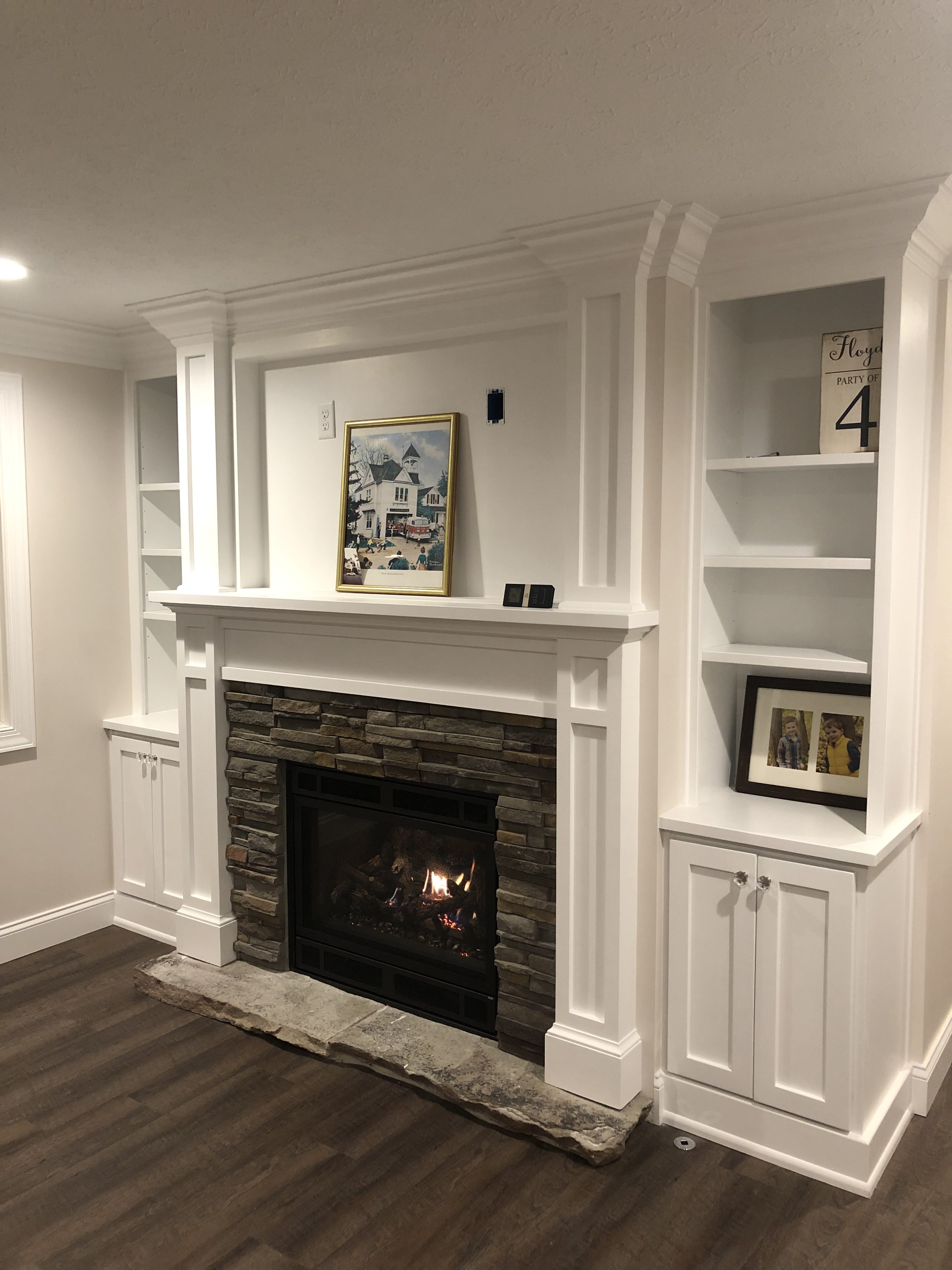 Image of a traditional 564 25K Gas Fireplace by Fireplace Xtordinair featuring stone surround and traditional painted white mantle.
