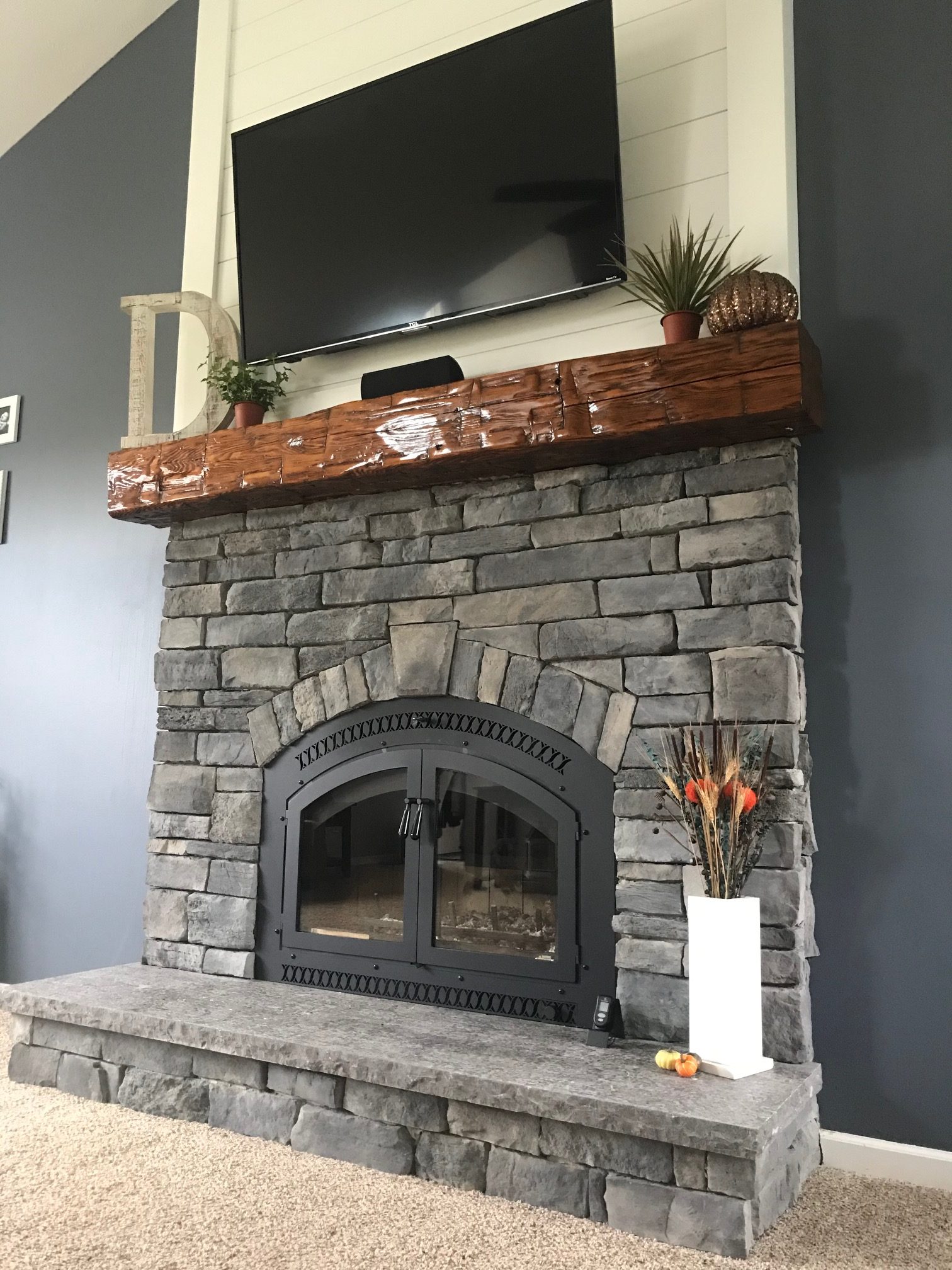Image of a traditional 44 Elite Wood Burning fireplace by Fireplace Xtordinair featuring stone surround and rustic beam mantle.