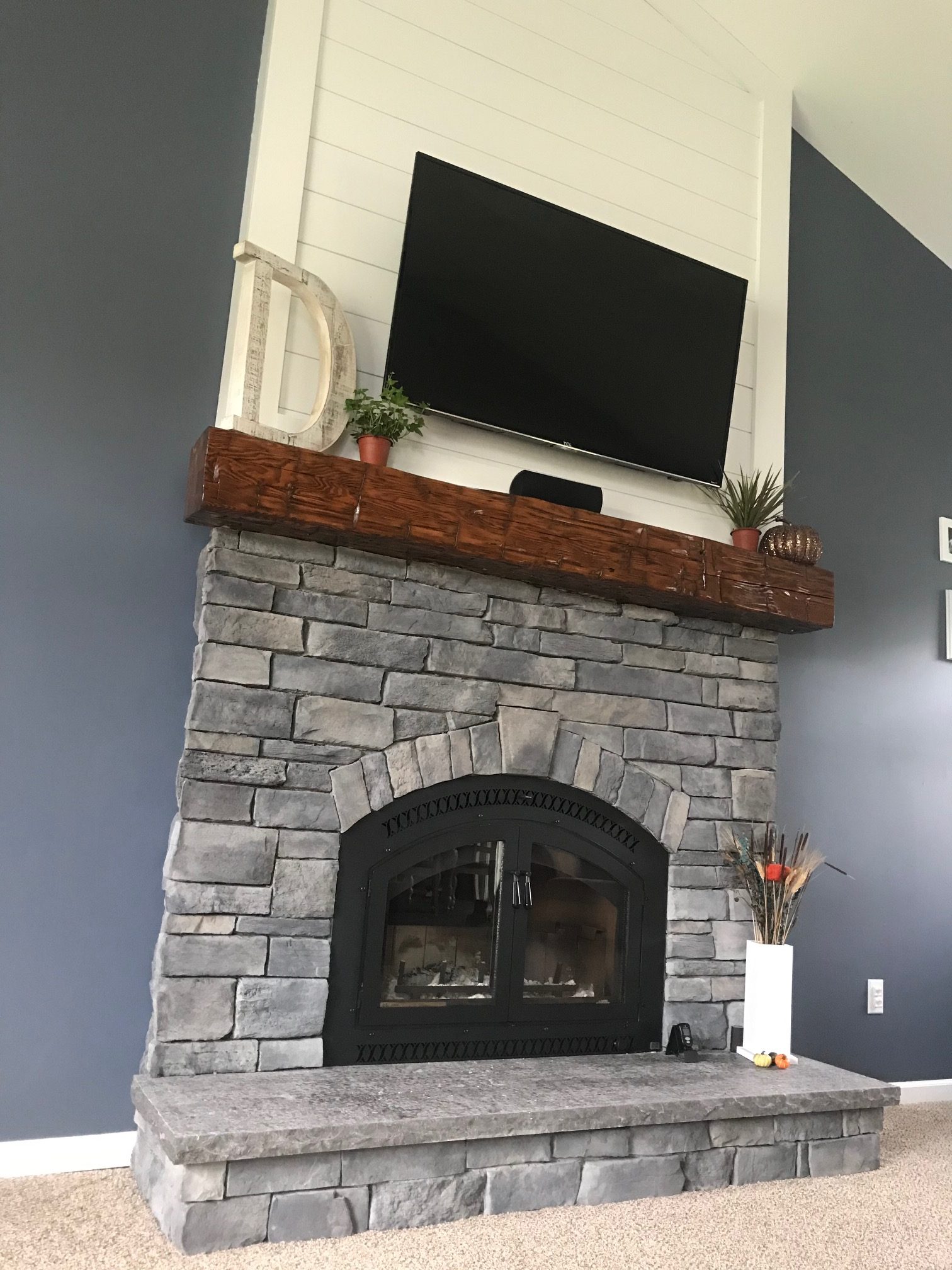 Image of a traditional 44 Elite Wood Burning fireplace by Fireplace Xtordinair featuring stone surround and rustic beam mantle.