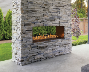 Image of a stunning see-thru 6424 Outdoor Gas Fireplace featuring an impressive 60-inch ribbon style burner with a link to the product page.